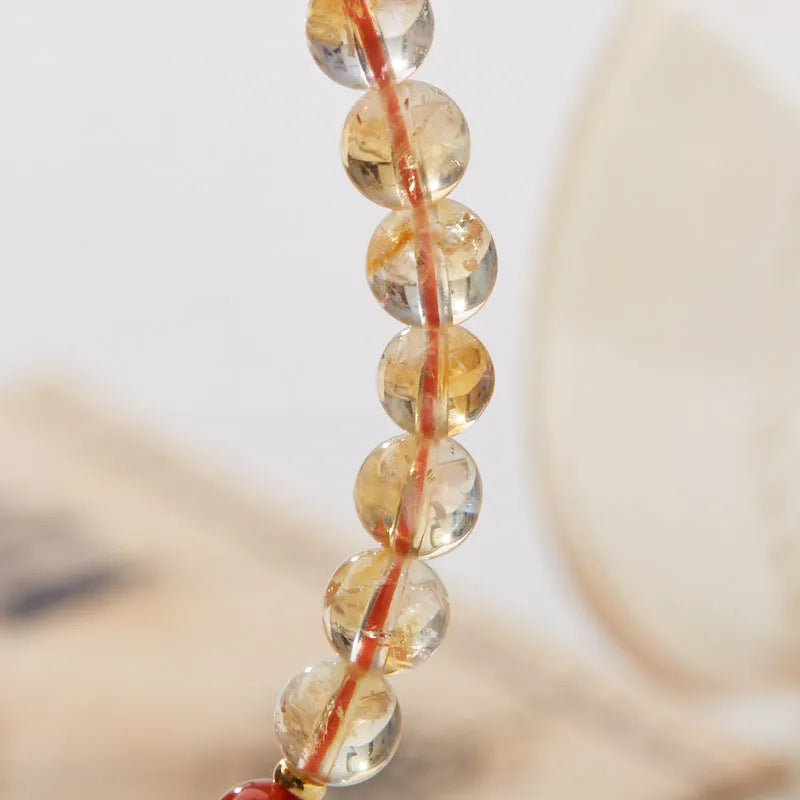Hand-woven citrine crystal bracelet with 6mm geometric beads on a wrist