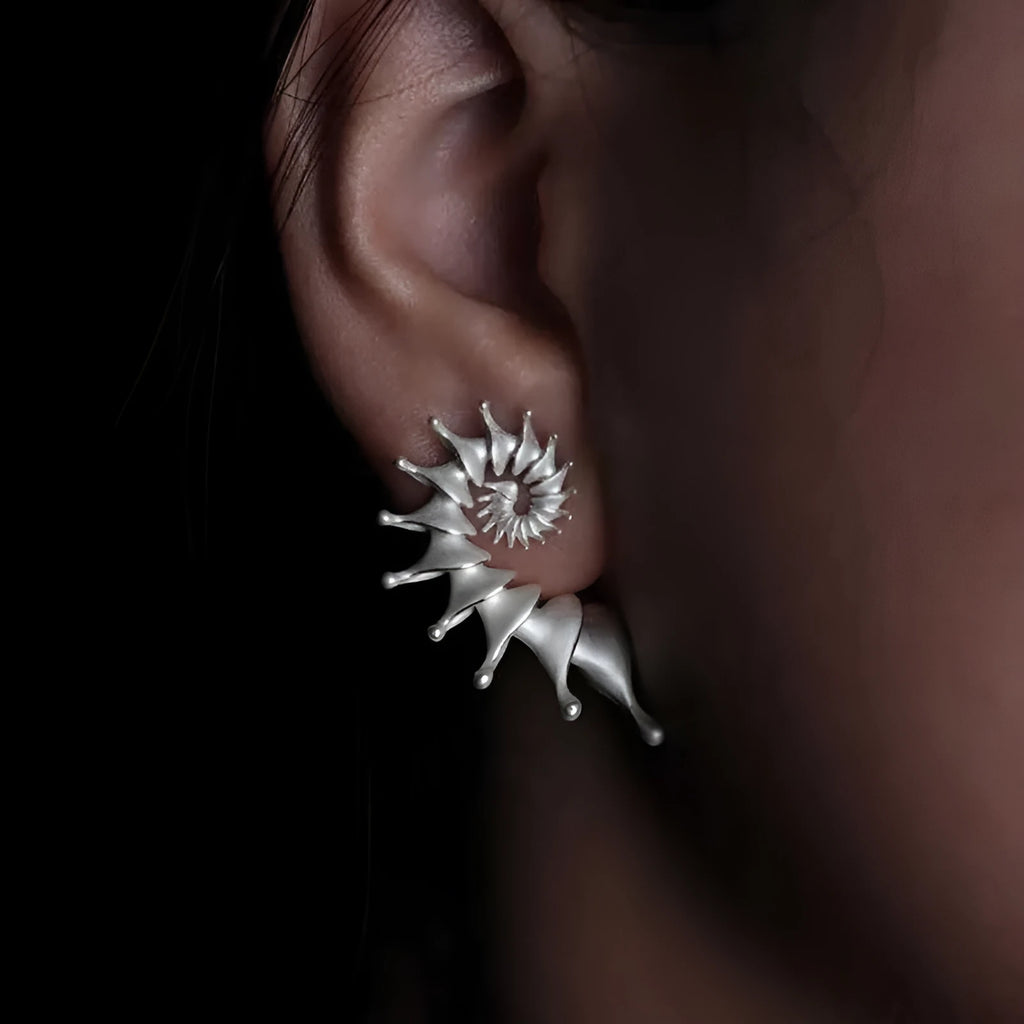 Matte finish conch stud earrings with three-dimensional shaping and irregular design elements