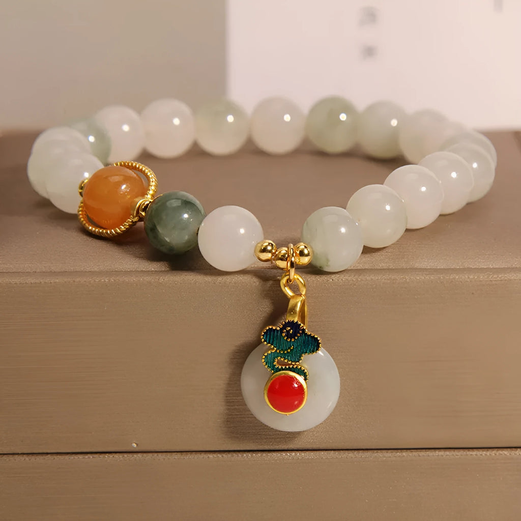 Women's ice jade crystal bracelet with pearl accents and a Xiangyun jade buckle on a white background.