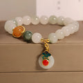 Women's ice jade crystal bracelet with pearl accents and a Xiangyun jade buckle on a white background.