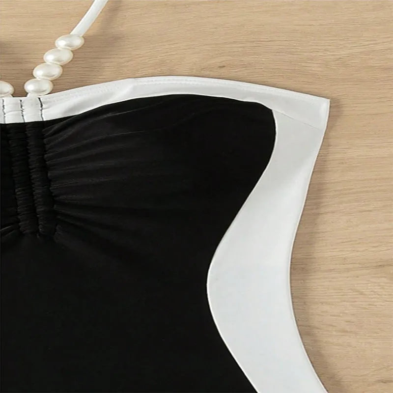 Black and white women's one-piece swimsuit with pearl spaghetti straps, sleeveless design