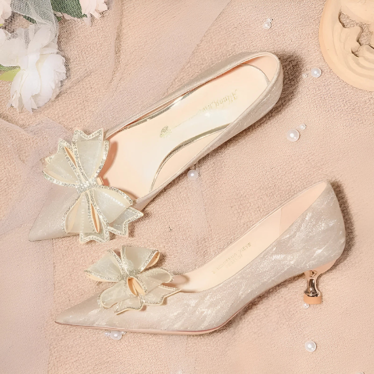 Women's champagne gold sequin pointed-toe stiletto heel pumps on a white background.