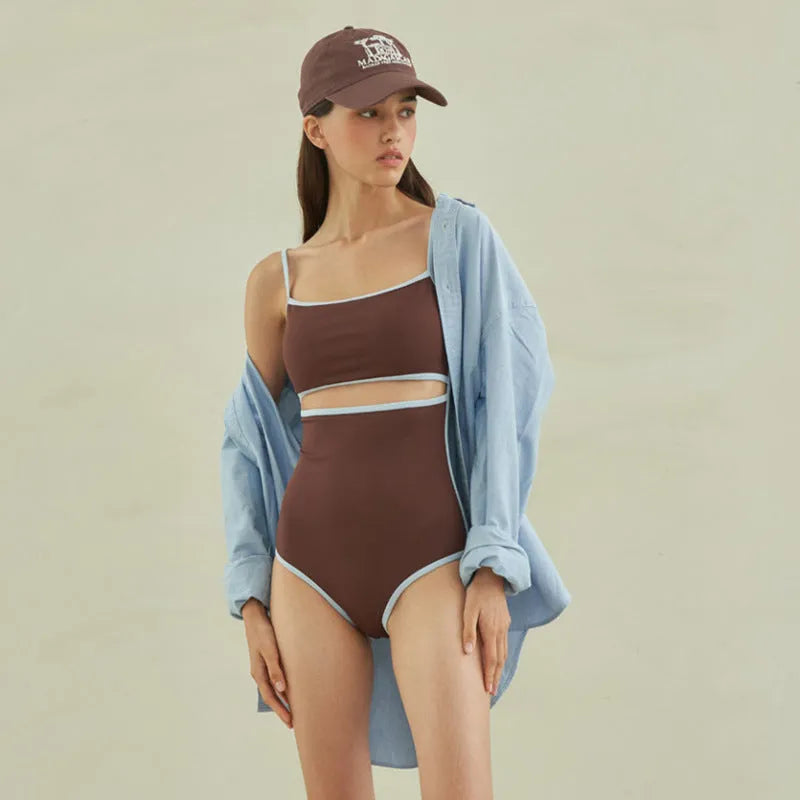 Brown women's one-piece swimsuit with a triangle top on a mannequin