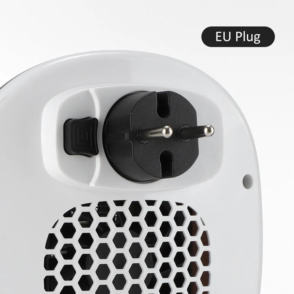 White ceramic electric heater with remote control on a table, showing air vent and control panel.