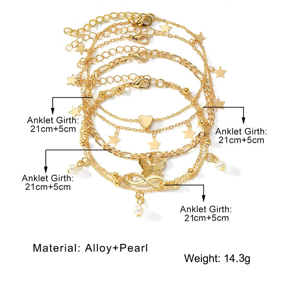 Set of four women's alloy anklets with butterfly, pearl, and heart charms.