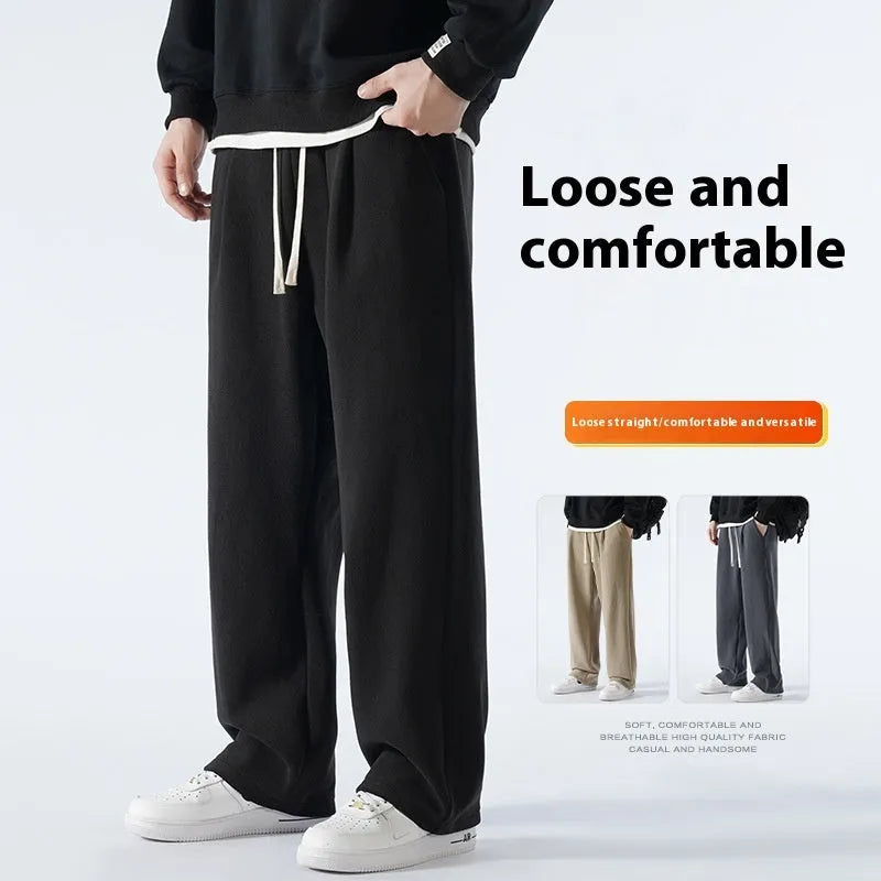 Men's loose fit apricot coloured fleece-lined sports pants with a drawstring waist on a hanger