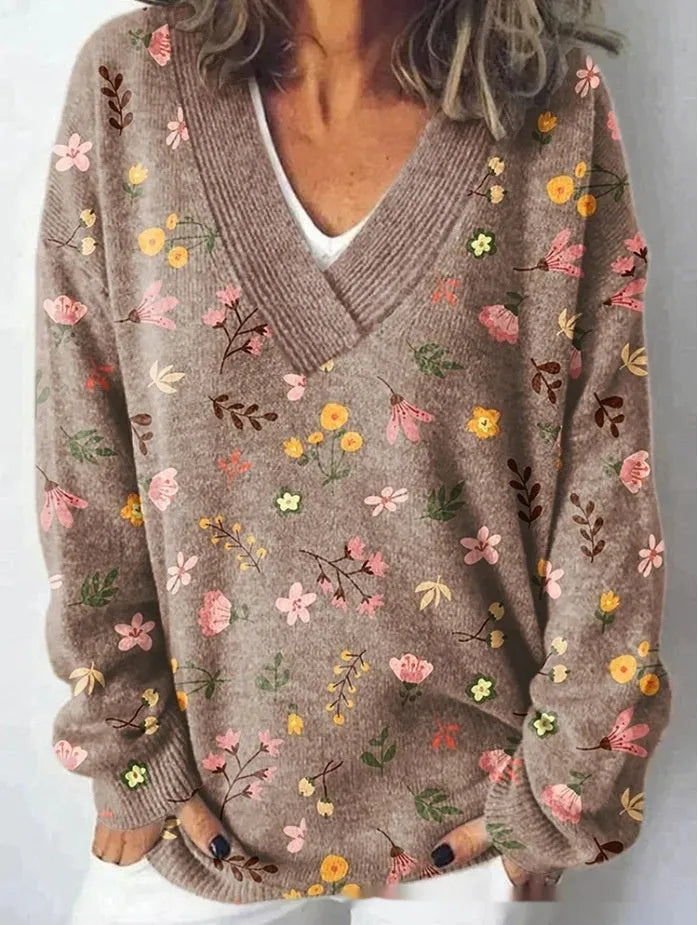 Women's grey V-neck sweatshirt with a white 3D floral pattern print and long sleeves.