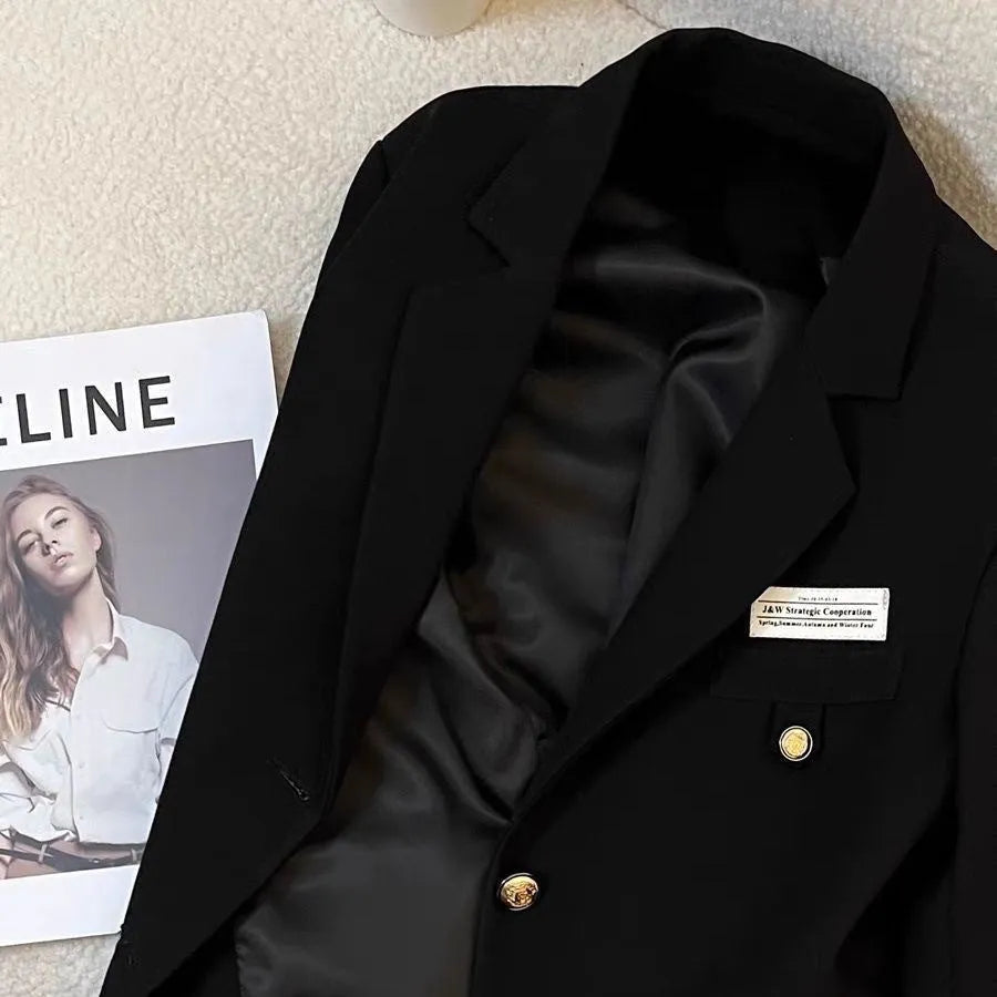 Women's black short suit coat with loose fit, long sleeves, and pockets for commuting style