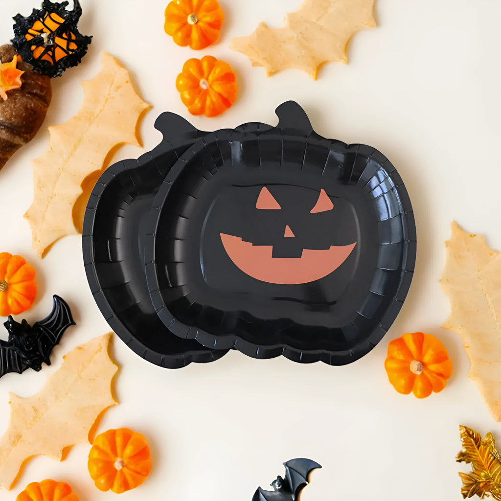 Black pumpkin design disposable paper plates measuring 9 inches in diameter, shown in Halloween party setting.