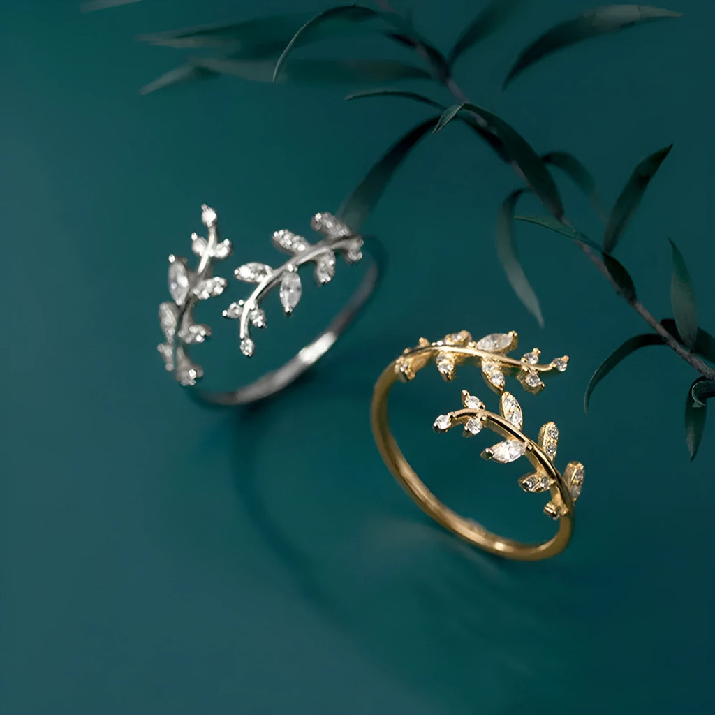 A geometric copper leaf-shaped ring for women, shown in both gold and silver electroplated finishes.