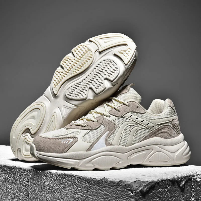 Men's beige and black collapse flat casual sneakers with low heel on a white background.