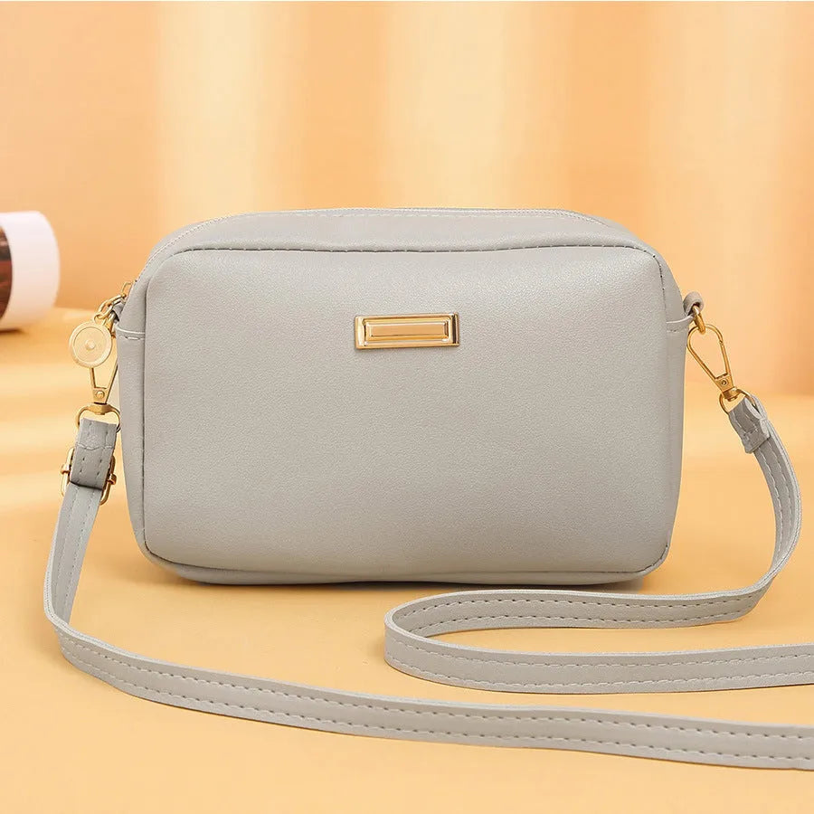 Women's solid colour PU shoulder bag with three-dimensional pocket in urban simplicity style