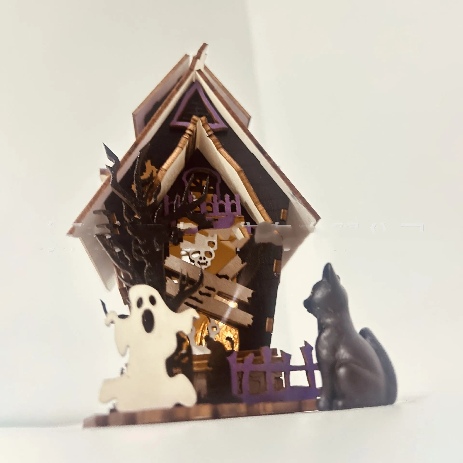 Wooden glowing haunted house Halloween table decoration with candlestick holder function.