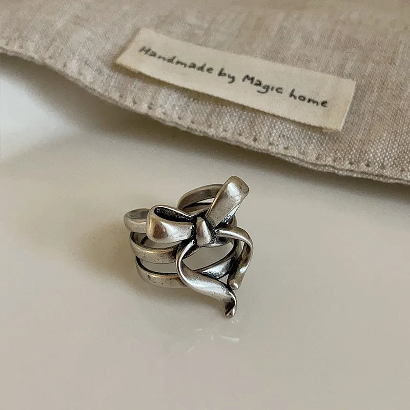 Gold plated wide open ring with retro distressed bow front and geometric metal shape for women