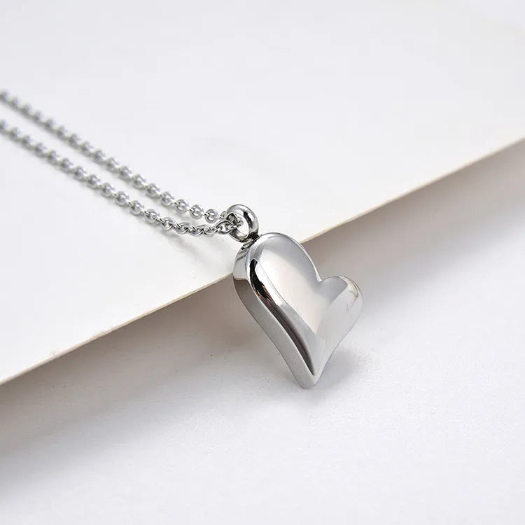 Silver curved peach heart pendant necklace on stainless steel chain with love pattern