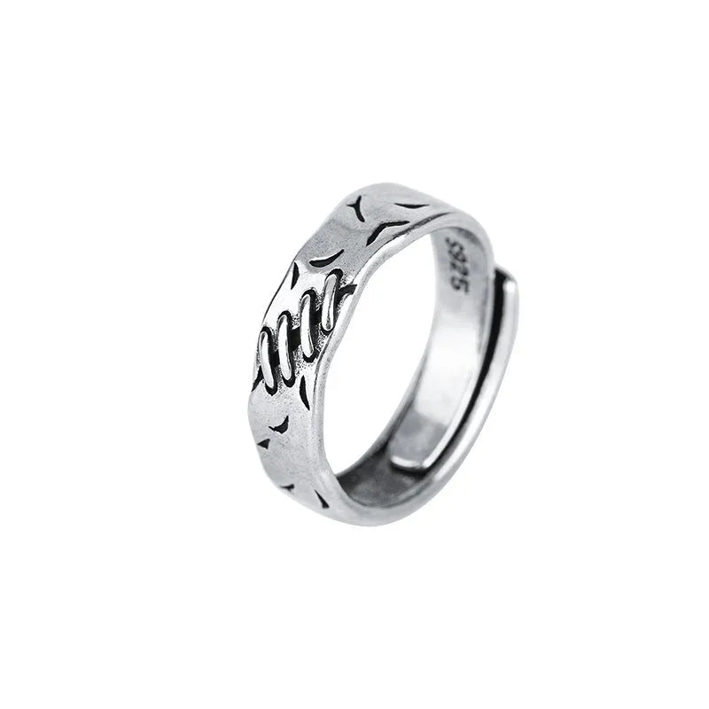 Black geometric copper ring with adjustable opening and round oval design elements