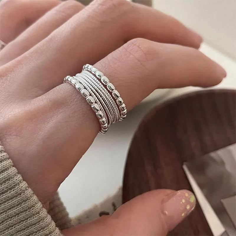 Adjustable copper alloy ring with woven twisted multilayer geometric design