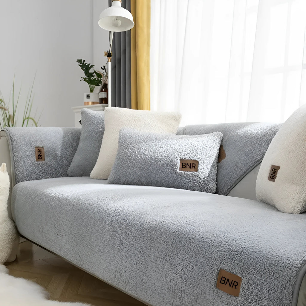 Lambswool sofa slipcover in a solid colour draped over a sofa, showing its simple cloth liner style.