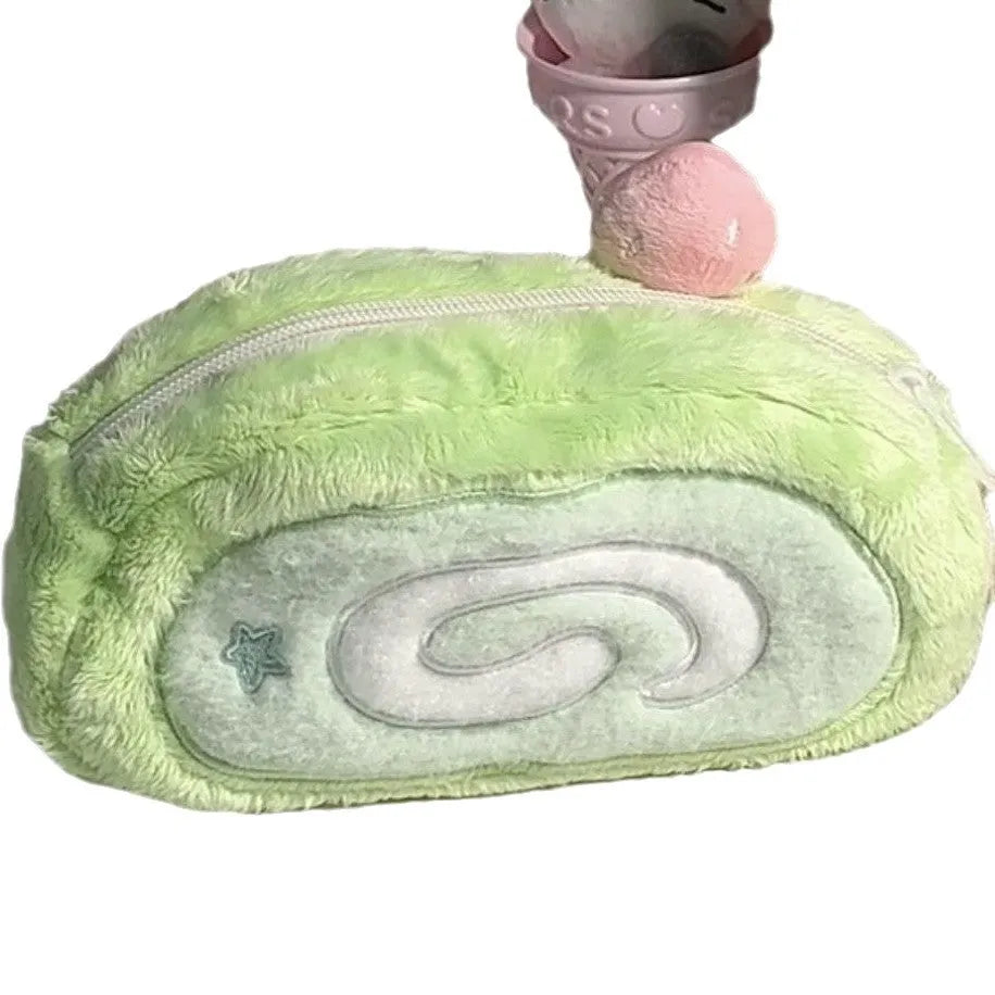 Swiss roll cake design pencil case in plush velvet with a zip closure.