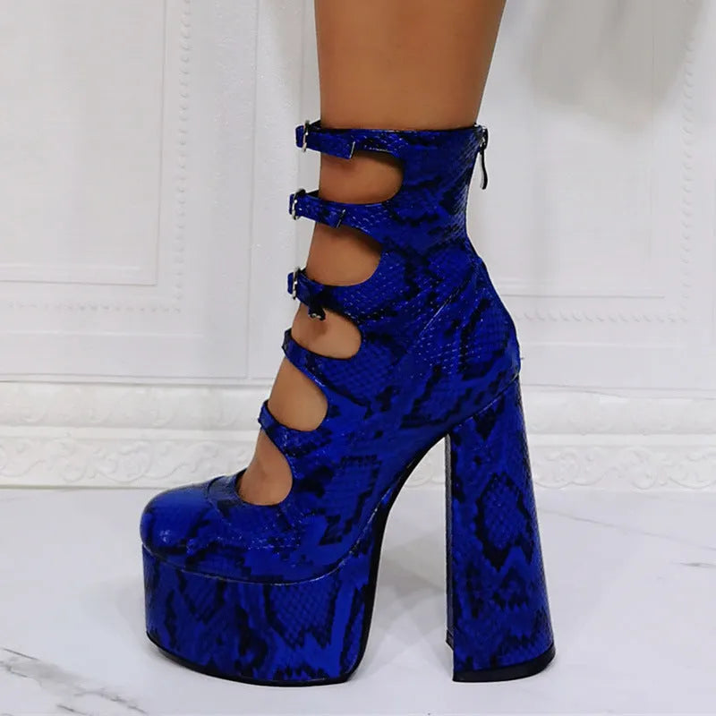 Black patent leather women's platform heel boots with a thick heel and a serpentine buckle strap.