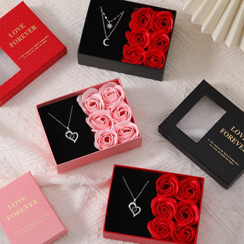 Red Korean style gift box open to show six pink soap flowers, with a matching handbag, for Valentine's Day.