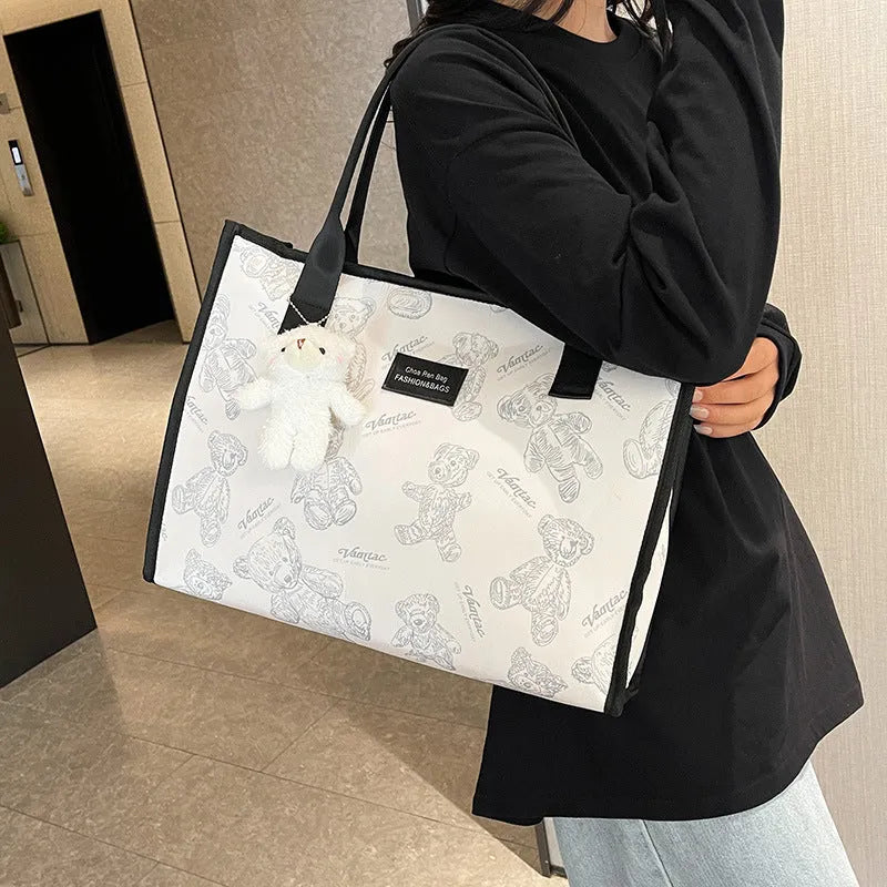 Women's black canvas tote bag with rhombus pattern and sandwich pocket
