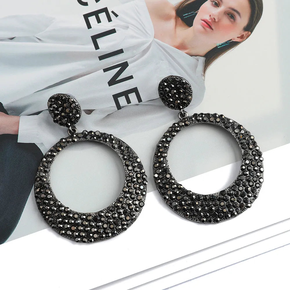 Colourful large round pendant drop earrings with cartoon style and diamond accents on metal alloy.