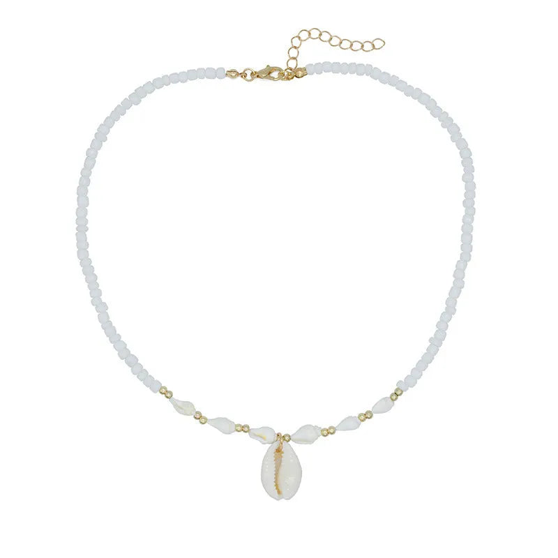 White necklace with a natural shell-shaped mother of pearl pendant on a metal chain.
