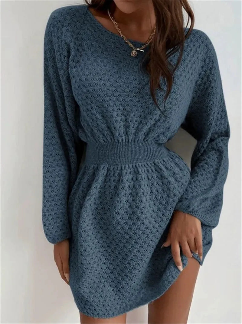 Blue women's knitted dress with hand-crocheted flowers, fitted waist, and round neck.