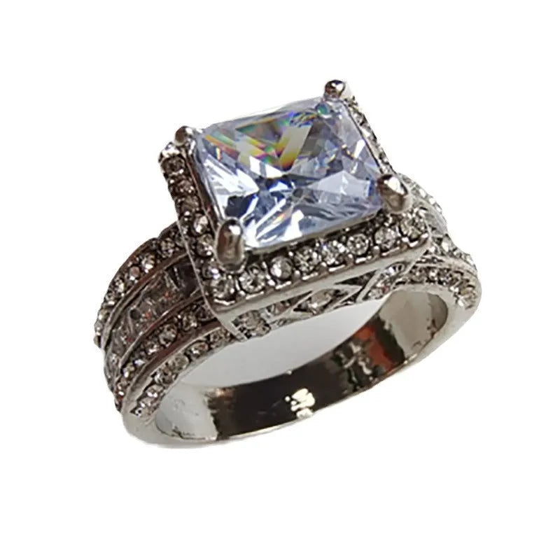 Women's geometric alloy ring with electroplated gold or white finish showing round design elements and available in sizes 5-13