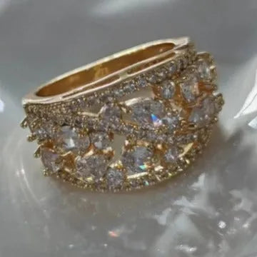 Women's hollow round fashion ring in gold or platinum finish with sapphire blue or white diamond accents