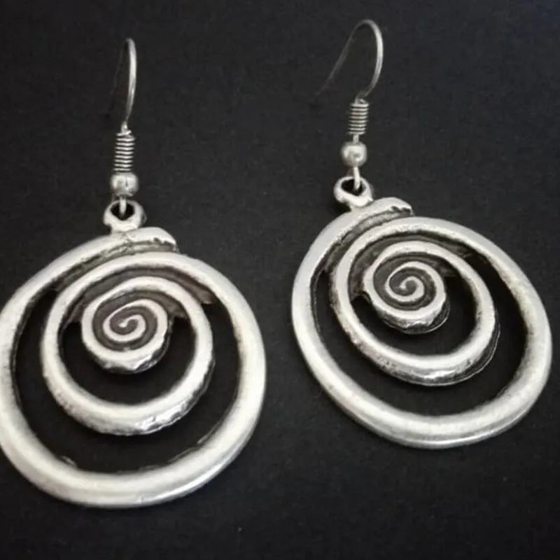 Silver geometric spiral earrings with distressed finish, measuring 2.6 by 5 centimetres