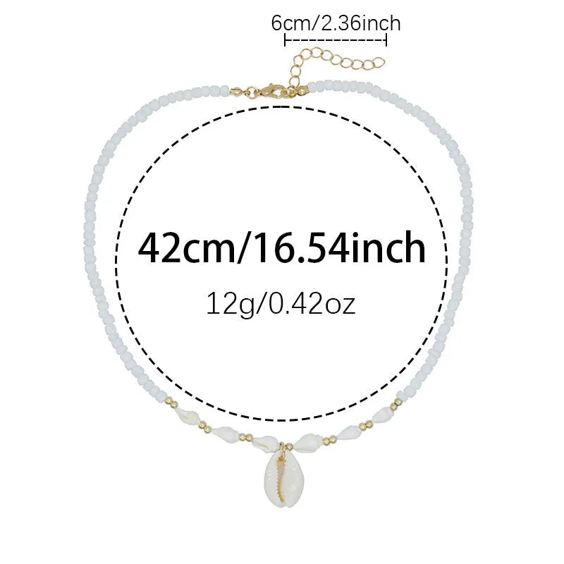 White necklace with a natural shell-shaped mother of pearl pendant on a metal chain.