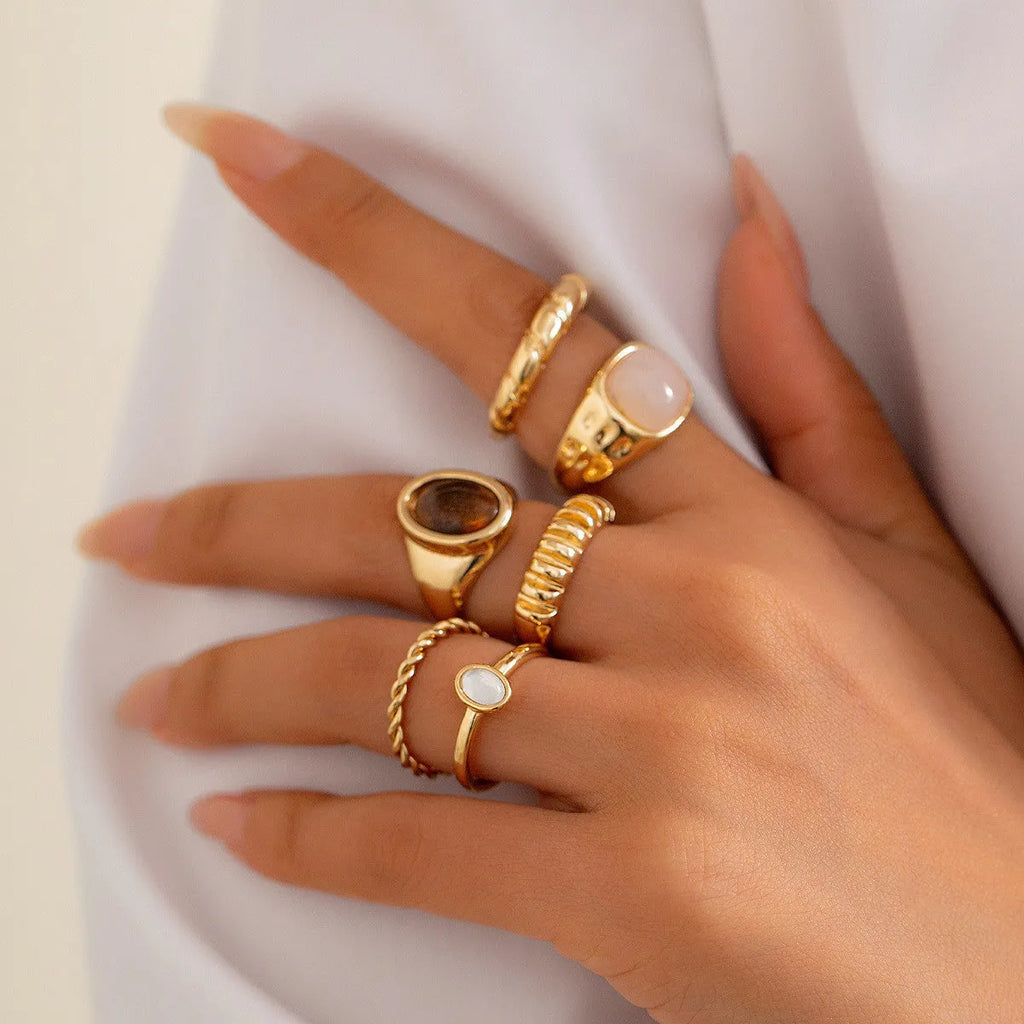 Light gold electroplated alloy ring set with six geometric and round designs for women