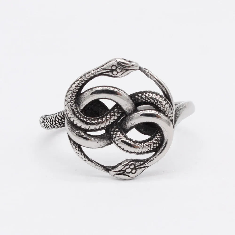 Close-up of a titanium steel double snake ring in retro style on a grey background