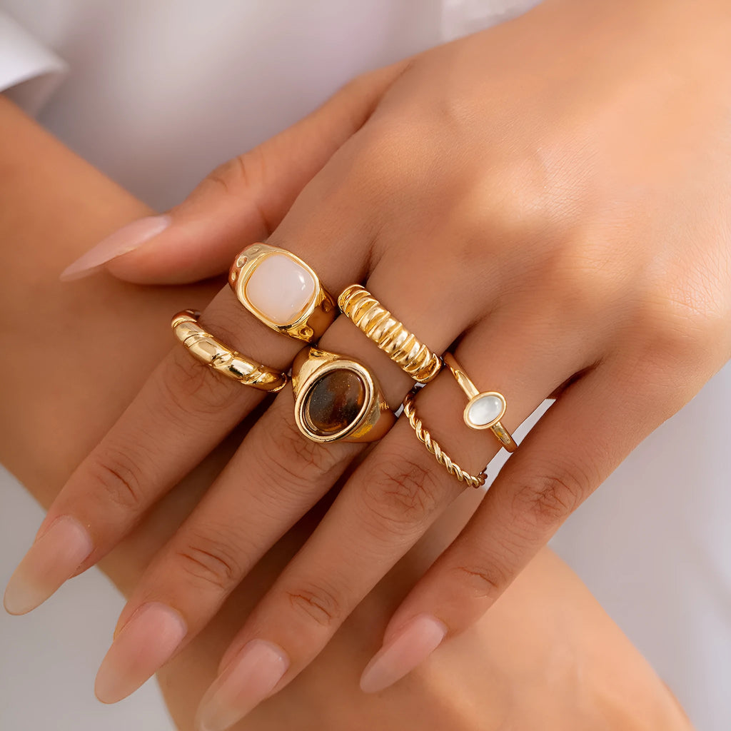 Light gold electroplated alloy ring set with six geometric and round designs for women