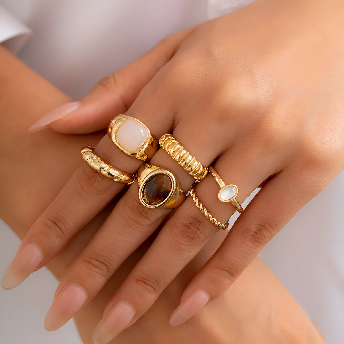 Light gold electroplated alloy ring set with six geometric and round designs for women