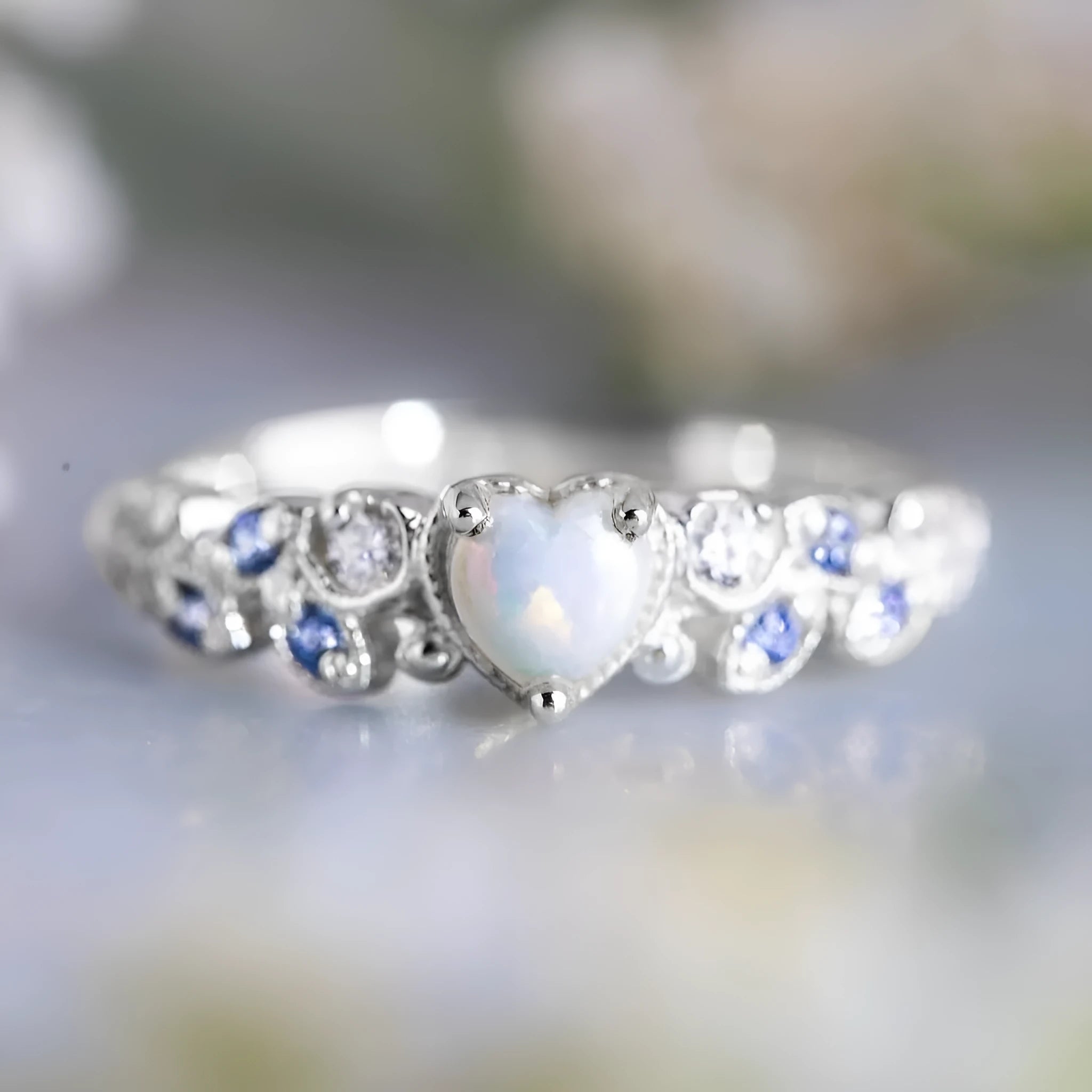 White electroplated alloy women's ring in a heart shape with floral and oceanic opal design details.