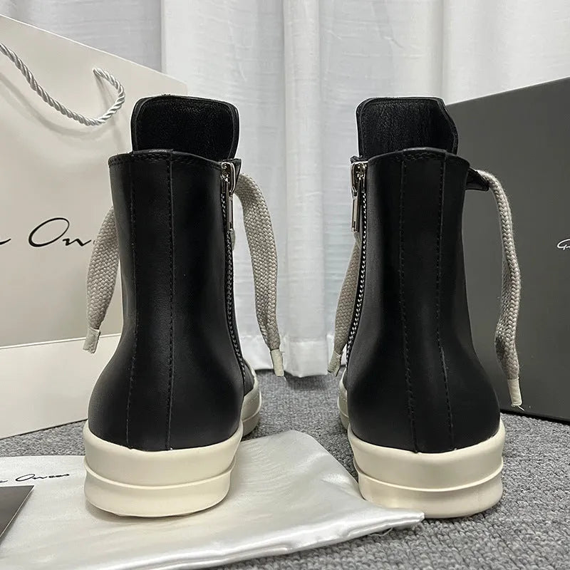 Black high-top leather sneakers with side zipper and round toe on a white background