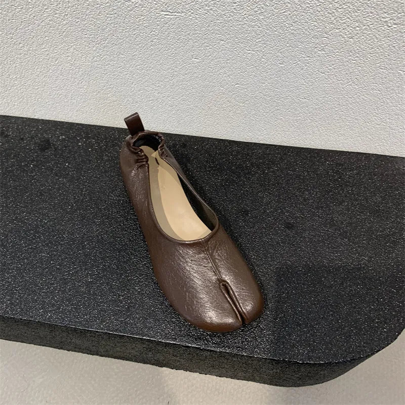 Women's apricot chunky heel pumps with a round toe and distinctive split toe horseshoe design.