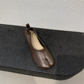 Women's apricot chunky heel pumps with a round toe and distinctive split toe horseshoe design.