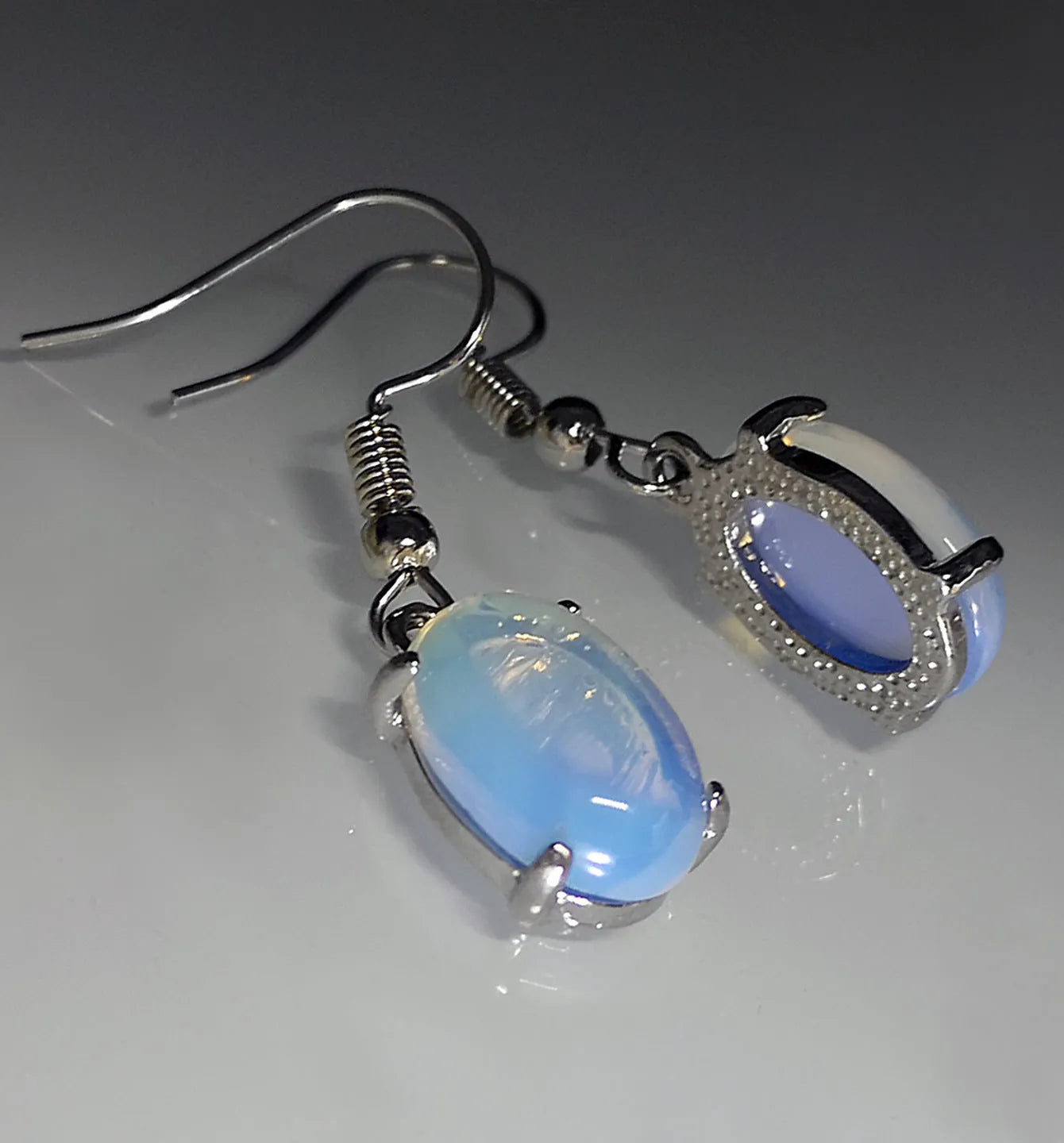 Moonlight white opal drop earrings with retro cross and ellipse design on alloy.