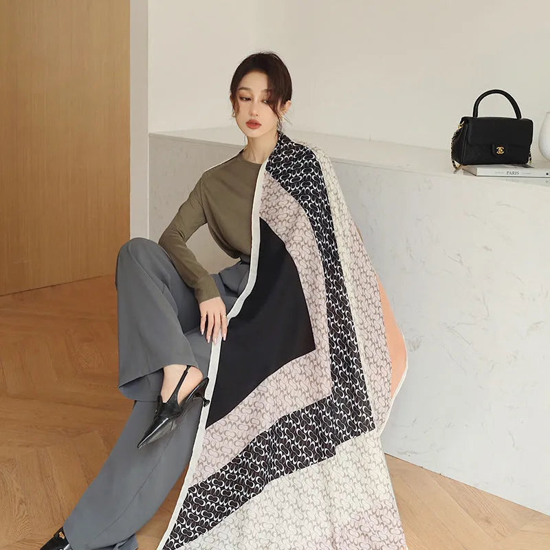 A woman wearing a long polyester scarf with fringe trim, shown in one of three available colour styles.