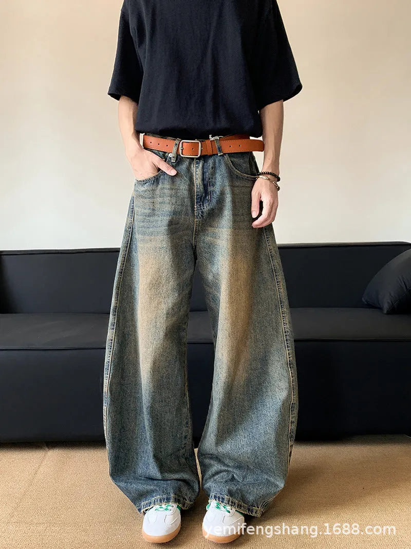 Men's retro blue distressed denim wide-leg trousers showing slim fit and vintage detailing