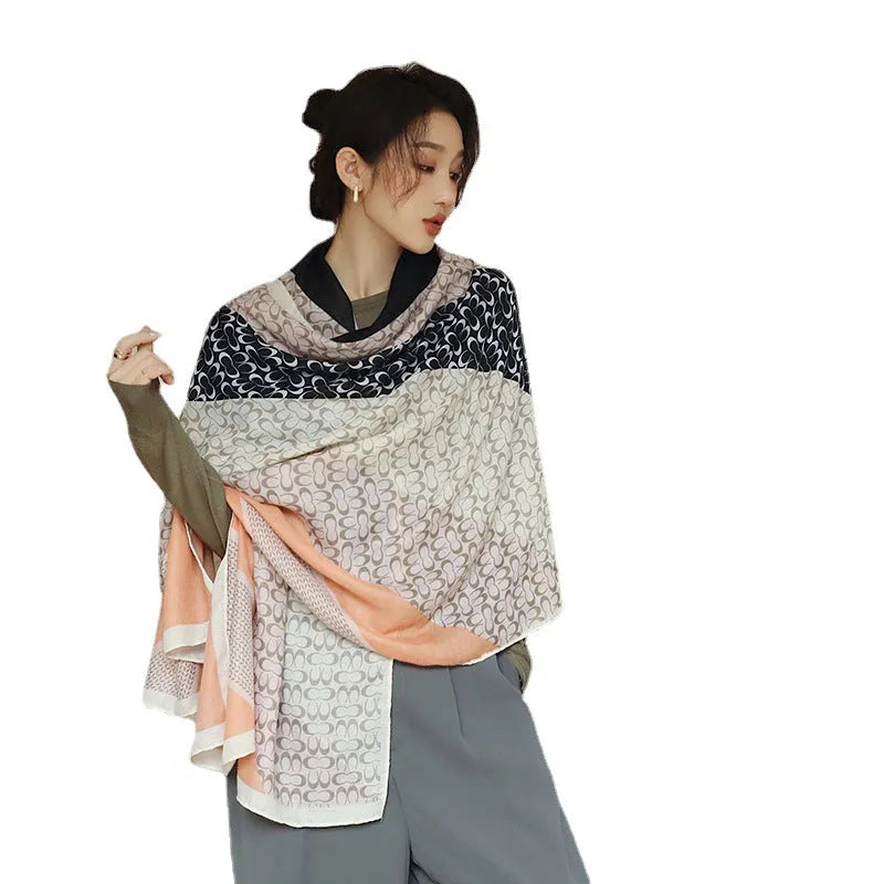 A woman wearing a long polyester scarf with fringe trim, shown in one of three available colour styles.