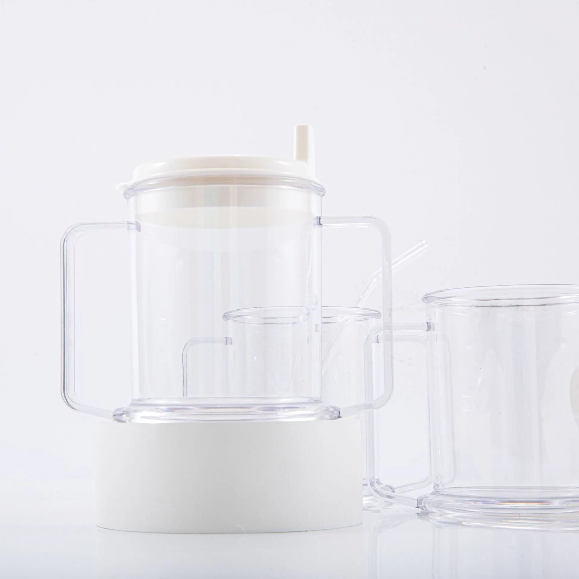 Clear transparent plastic spill-proof drinking cup with modern design.
