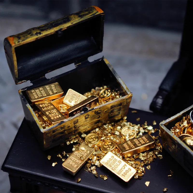 Miniature alloy treasure chest doll house ornament with gold coin and bar design.