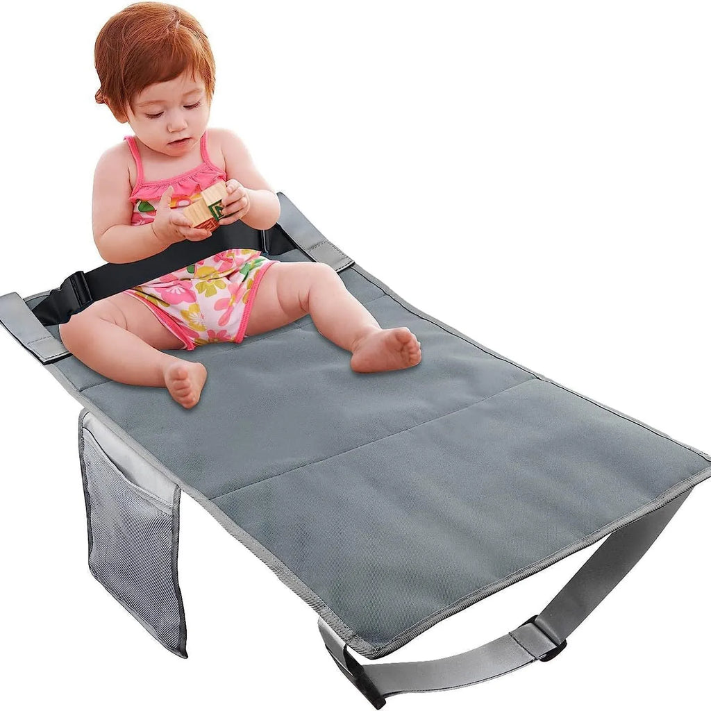 Blue children's aircraft seat extender with adjustable straps attached to plane seat
