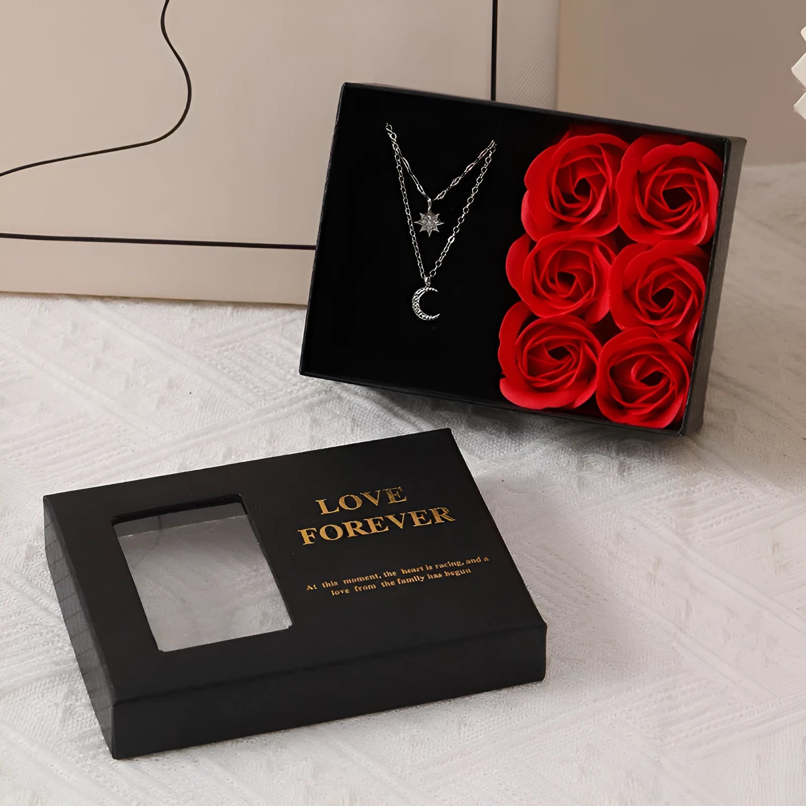 Red Korean style gift box open to show six pink soap flowers, with a matching handbag, for Valentine's Day.