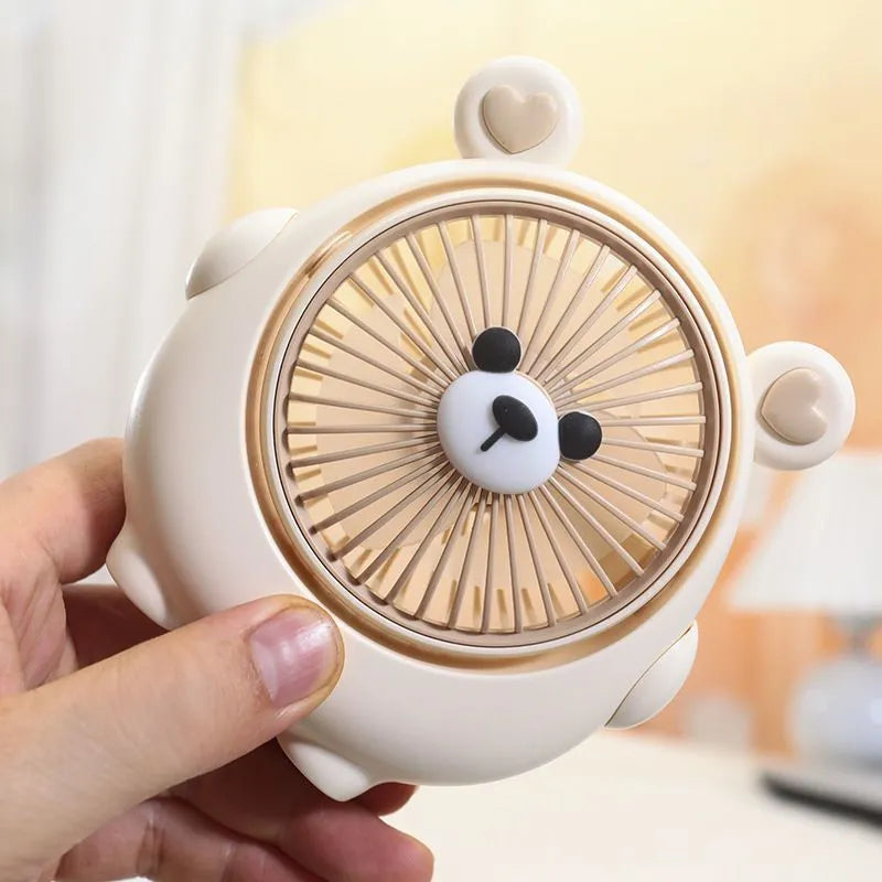 Cute dog design USB desktop electric fan in bear apricot colour on a wooden desk.